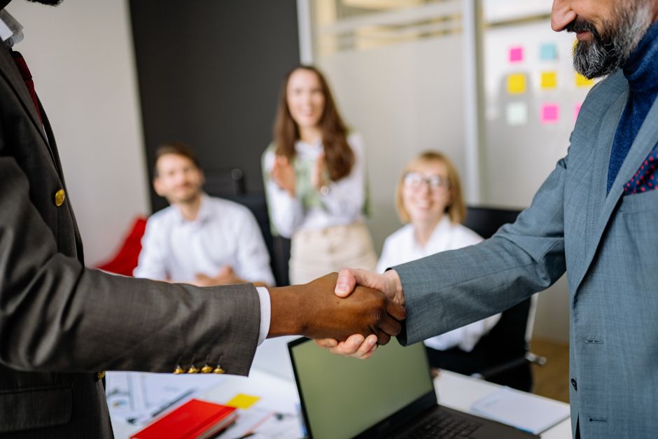 Real estate professionals shaking hands after a successful meeting