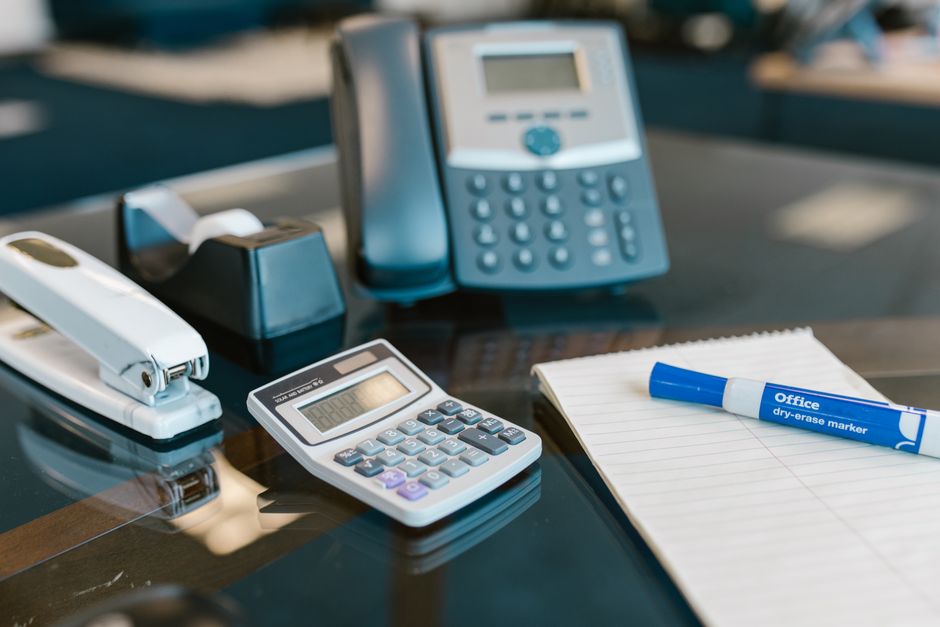 Organized office workspace with desk and phone, representing brokerage operations