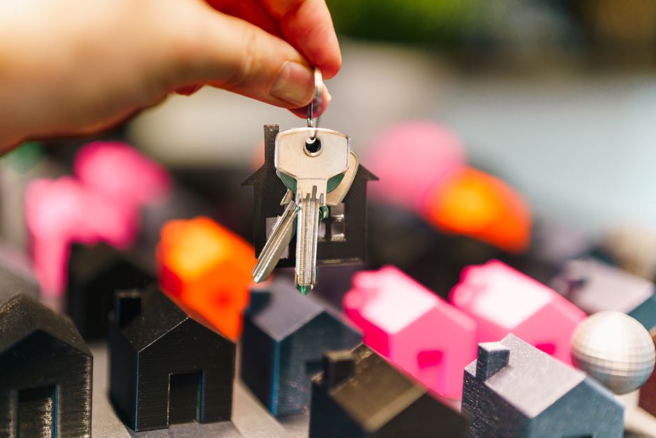 Close-up of house keys being handed over, symbolizing closing day