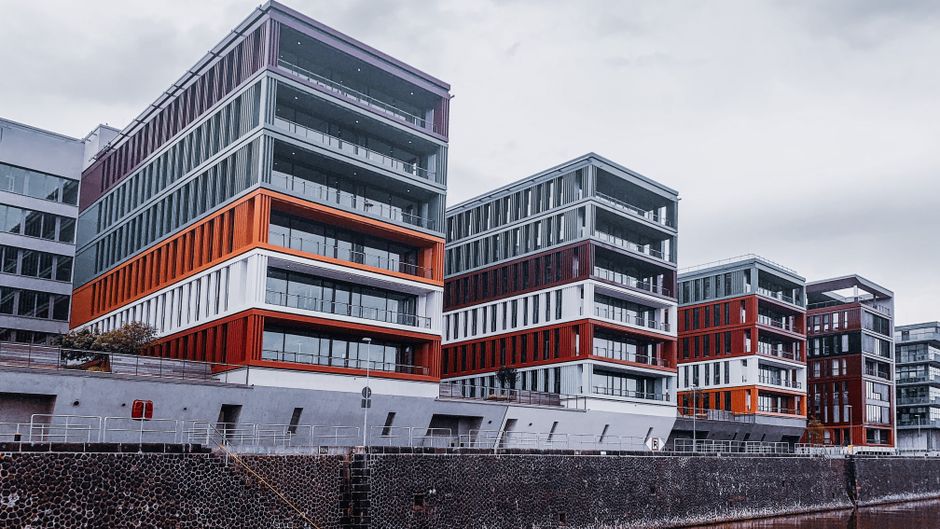 Modern multi-story apartment building exterior with balconies