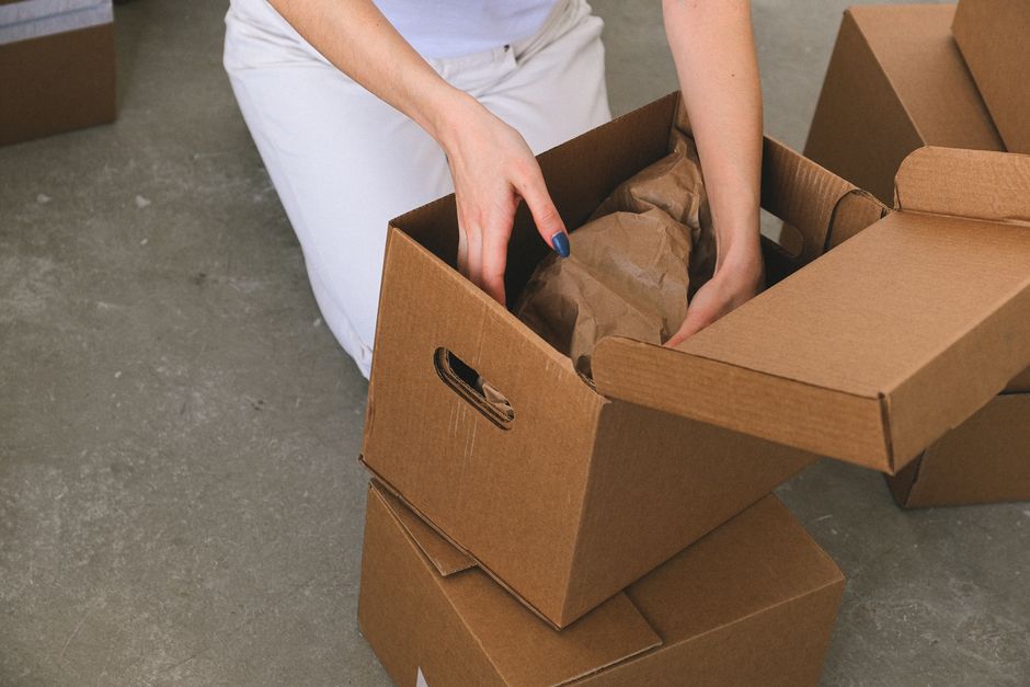 Labeled moving boxes stacked in a bright room during a move-in