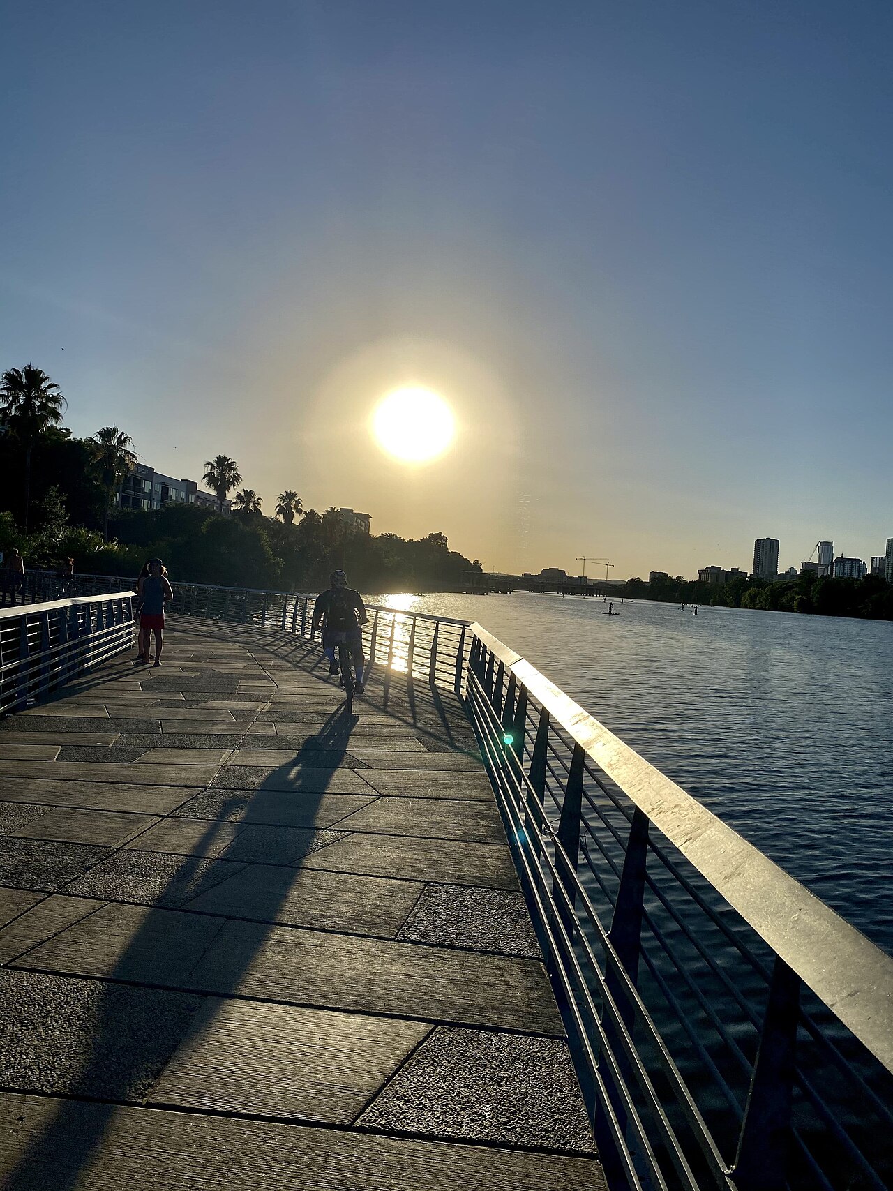 Boardwalk trail along Lady Bird Lake in Austin with skyline in the background