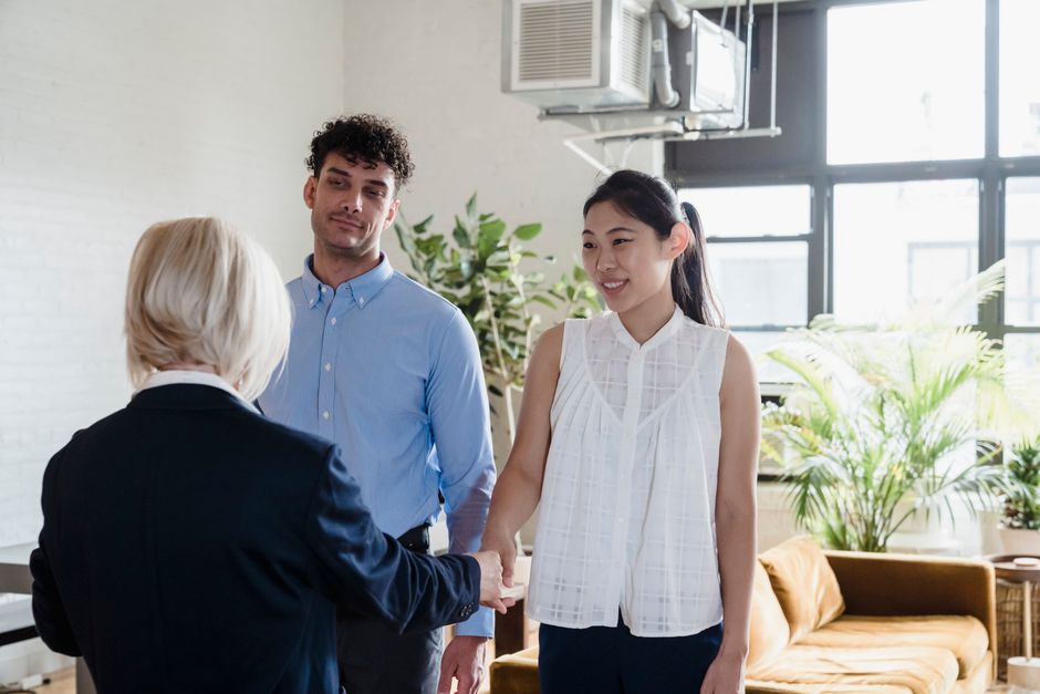 Real estate agent reviewing paperwork with sellers at a table